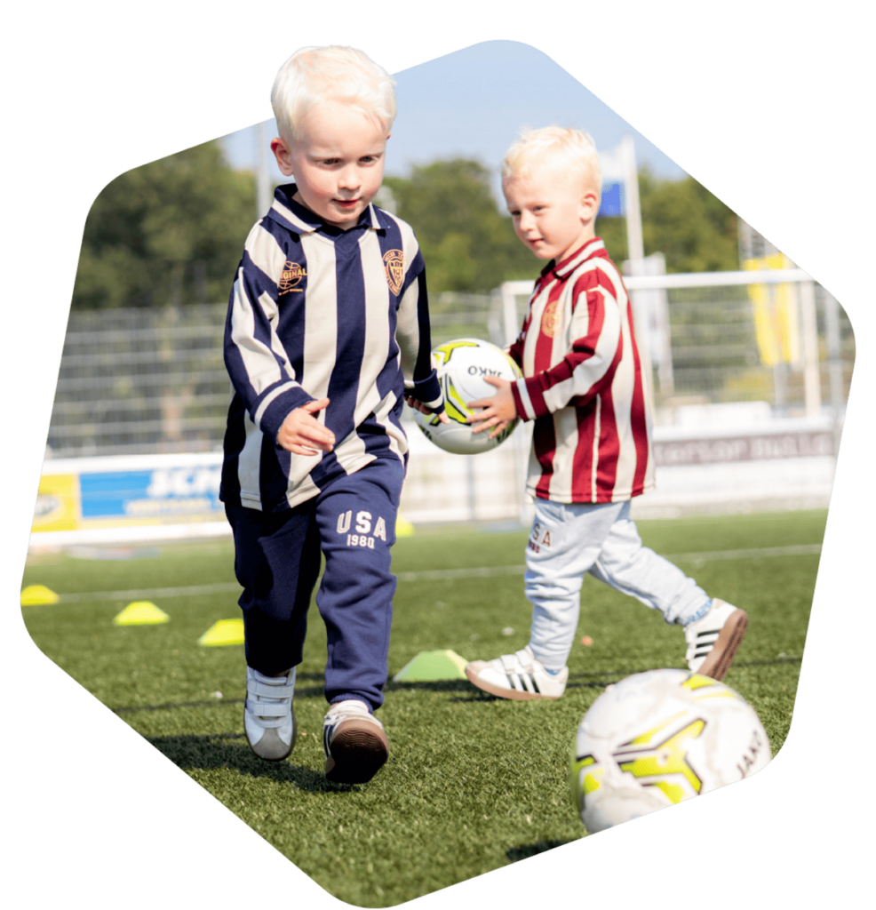 Twee jonge kinderen spelen met een voetbal tijdens peutergym in Zwolle op het voetbalveld bij MiniSkills.