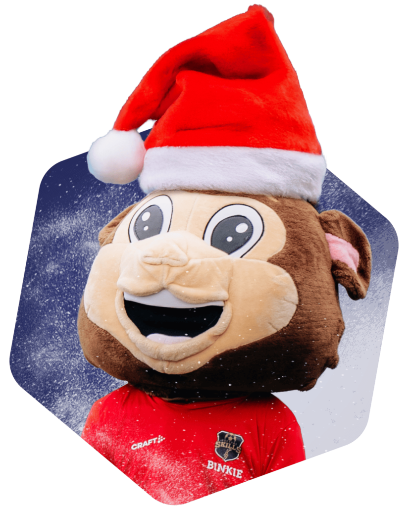 Mascotte Binkie van FC VoetbalSkills poseert vrolijk met een opvallende kerstmuts.